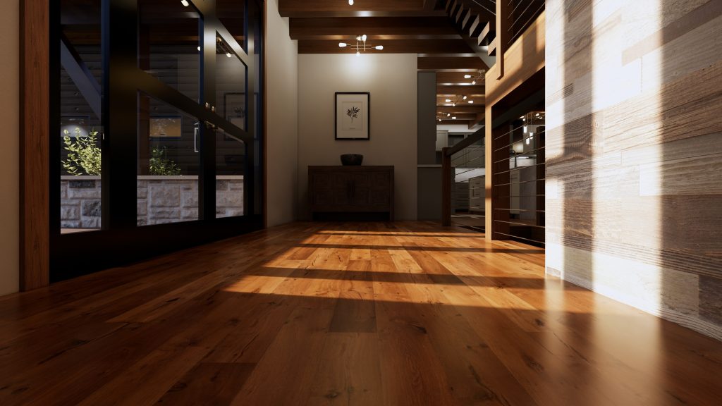 Sunlit interior hallway of a modern mountain home with warm wood flooring, exposed timber beams, a wood-clad wall, large dark-framed windows, cable railing, and a wooden console beneath framed botanical artwork.
